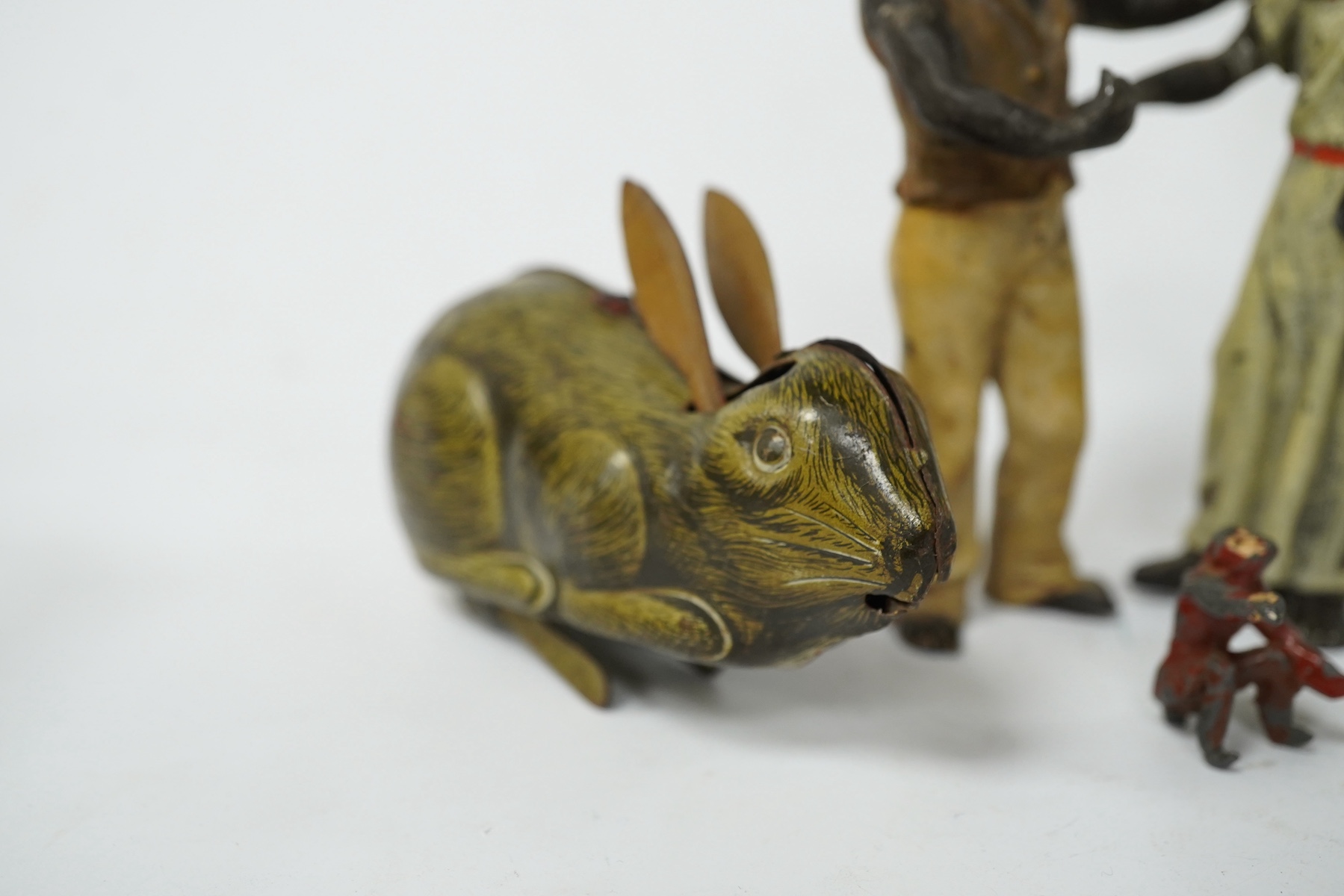 A collection of cold-painted figures and a tinplate and clockwork hare, largest 10cm high. Condition - fair